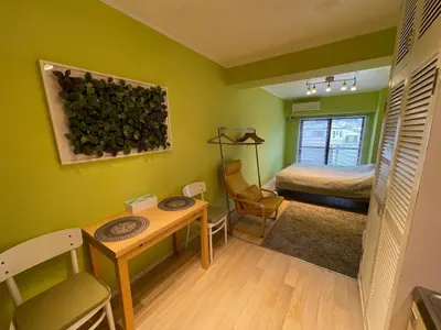 a small room with a table and a bed at only 2 stops to shibuya sangenjaya apt in Tokyo