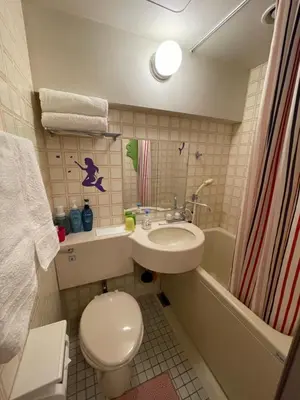 a bathroom with a toilet and a sink and a tub at only 2 stops to shibuya sangenjaya apt in Tokyo
