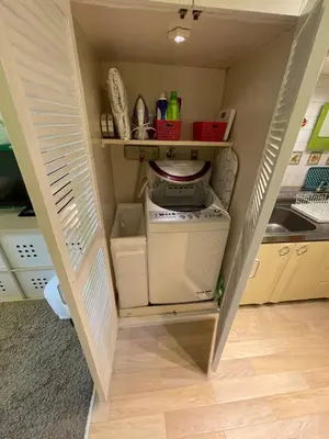 a small kitchen with a small refrigerator in a room at only 2 stops to shibuya sangenjaya apt in Tokyo