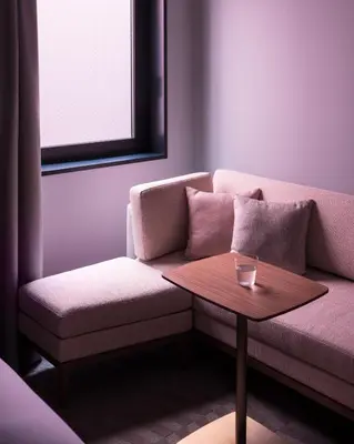 a living room with a couch and a table at Bespoke Hotel Shinjuku in Tokyo