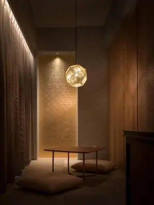 a dining room with a table and a light fixture at Bespoke Hotel Shinjuku in Tokyo