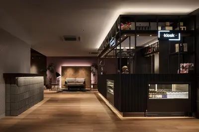 a lobby of a store with a couch and a chair at Bespoke Hotel Shinjuku in Tokyo