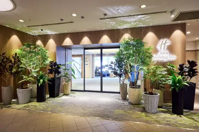 a lobby with a bunch of potted plants at ANA Holiday Inn Tokyo Bay by IHG in Tokyo