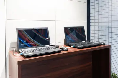two laptop computers sitting on top of a desk at Pearl Hotel Shinjuku Akebonobashi in Tokyo