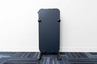 a black suitcase standing next to a wall at Pearl Hotel Shinjuku Akebonobashi in Tokyo