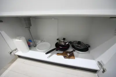 a small kitchen with a shelf with a pot and pans at Sorapia Tokyo in Tokyo