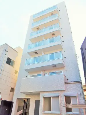 a tall white apartment building with windows at Sorapia Tokyo in Tokyo