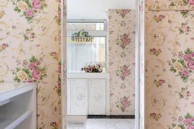 a bathroom with pink floral wallpaper and a window at Papillon Paradis Nishi-Shinjuku in Tokyo