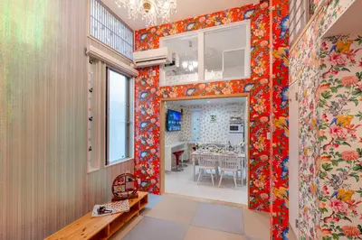 a dining room with orange flowers on the walls at Papillon Paradis Nishi-Shinjuku in Tokyo