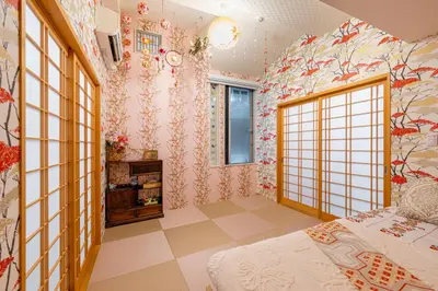 a bedroom with a bed and floral wallpaper at Papillon Paradis Nishi-Shinjuku in Tokyo