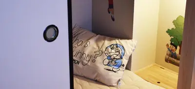 a bed with a pillow with a cartoon face on it at Tokyo inn Sakura An in Tokyo