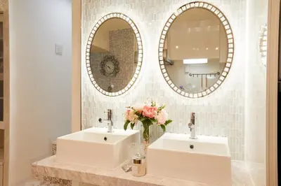 two sinks in a bathroom with two mirrors at Papillon Paradis Higashi-Shinjuku in Tokyo