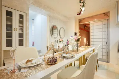 a dining room with a long table and white chairs at Papillon Paradis Higashi-Shinjuku in Tokyo