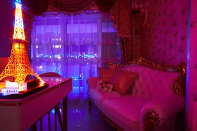 a purple room with a couch and a table and a lamp at Papillon Paradis Higashi-Shinjuku in Tokyo