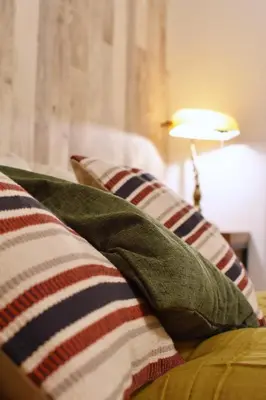 a couch with a pillow on it with a lamp at Origami Residential Suite - Tokyo Asakusa Skytree in Tokyo