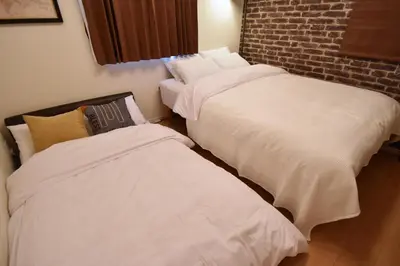 two beds sitting next to each other in a room at Origami Residential Suite - Tokyo Asakusa Skytree in Tokyo