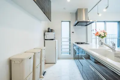 a white kitchen with a sink and a refrigerator at QiQi House Tokyo まるごと新築一軒家宿 Spacious New Home, 8 Guests, Easy Airport & Disney Access in Tokyo