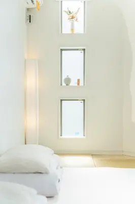 a bedroom with a bed and two windows at QiQi House Tokyo まるごと新築一軒家宿 Spacious New Home, 8 Guests, Easy Airport & Disney Access in Tokyo