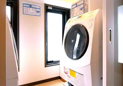 a washing machine in a room with a window at Hotel Trend Asakusa Tawaramachi in Tokyo