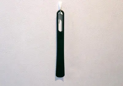 a black candle on a white wall at Hotel Trend Asakusa Tawaramachi in Tokyo