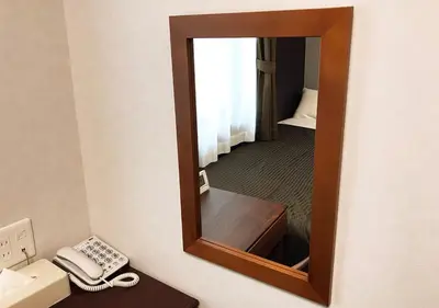 a mirror in a hotel room with a phone and a desk at Hotel Trend Asakusa Tawaramachi in Tokyo