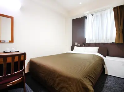 a bedroom with a large bed and a window at Hotel Trend Asakusa Tawaramachi in Tokyo