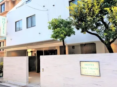 a white building with a sign in front of it at Hotel New Takada in Tokyo