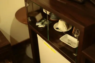 a small refrigerator in a wooden cabinet at Hotel New Takada in Tokyo