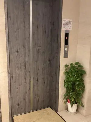 a door in a building with a potted plant at Hotel New Takada in Tokyo