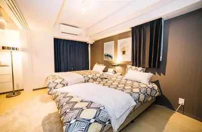 a bedroom with two beds and a window at Universal Haneda in Tokyo