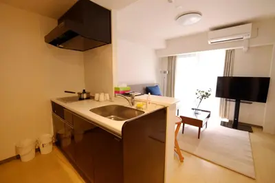 a kitchen with a sink and a large window at Universal Haneda in Tokyo