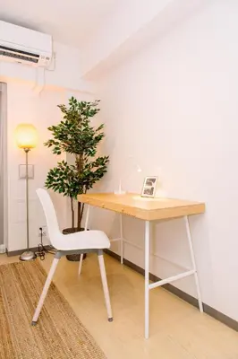 a desk with a chair and a tree in a room at Universal Haneda in Tokyo