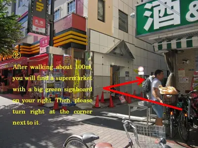 a man is standing on a street with a bicycle at Shin Okubo Sekitei in Tokyo