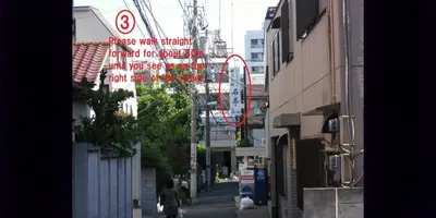 a street with a sign on the side of a building at Shin Okubo Sekitei in Tokyo