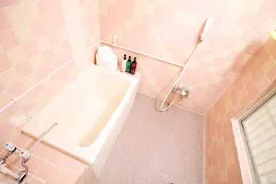 a bathroom with a tub with two bottles on it at Shin Okubo Sekitei in Tokyo