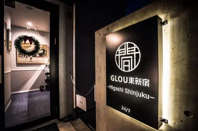 a sign on the door of a building at GLOU Higashi Shinjuku in Tokyo