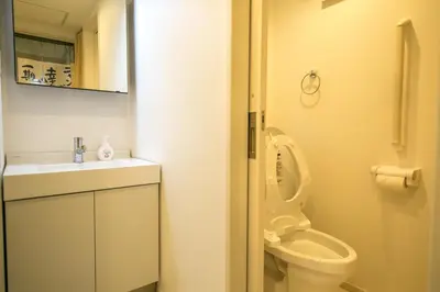 a small bathroom with a toilet and a sink at Takadanobaba 3-1F in Tokyo