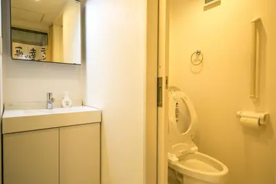 a bathroom with a toilet and a sink at Takadanobaba 3-1F in Tokyo