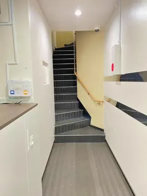 a hallway with a staircase in a building at Amber Iidabashi in Tokyo