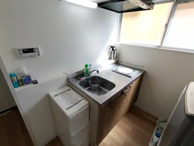 a small bathroom with a sink and a washer at Amber Iidabashi in Tokyo