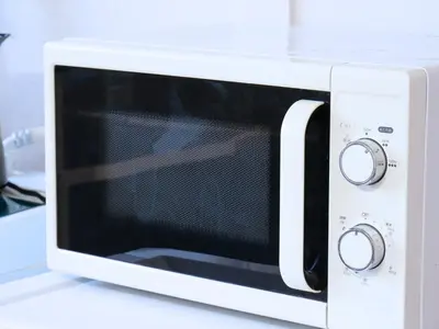 a white microwave oven sitting on top of a counter at Amber Iidabashi in Tokyo