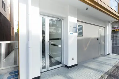 an entrance to a building with sliding glass doors at Amber Iidabashi in Tokyo