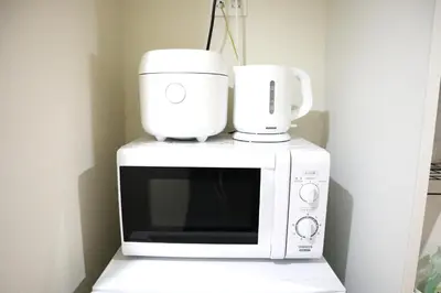 a microwave with two coffee cups on top of it at Shibuya Stay Tokyo A101 in Tokyo