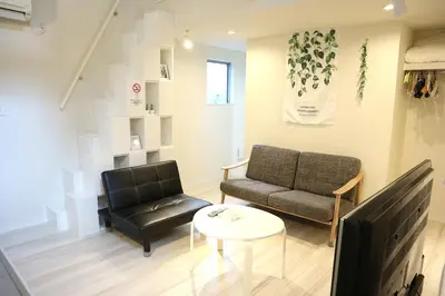 a living room with a couch and a table at Shibuya Stay Tokyo A101 in Tokyo