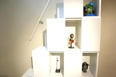 a room with toy figurines on a white wall at Shibuya Stay Tokyo A102 in Tokyo