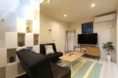 a living room with a couch and a flat screen tv at Shibuya Stay Tokyo A102 in Tokyo