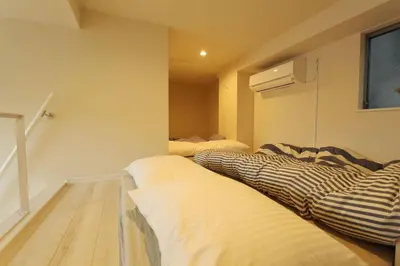 a bedroom with two beds and a window at Shibuya Stay Tokyo A102 in Tokyo