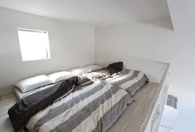 a bed in a white room with a window at Shibuya Stay Tokyo A202 in Tokyo
