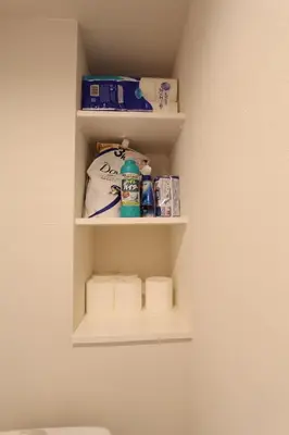 a bathroom shelf with toiletries on a wall at Shibuya Stay Tokyo A202 in Tokyo