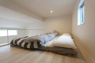 a bedroom with a bed and a wooden floor at Shibuya Stay Tokyo A203 in Tokyo